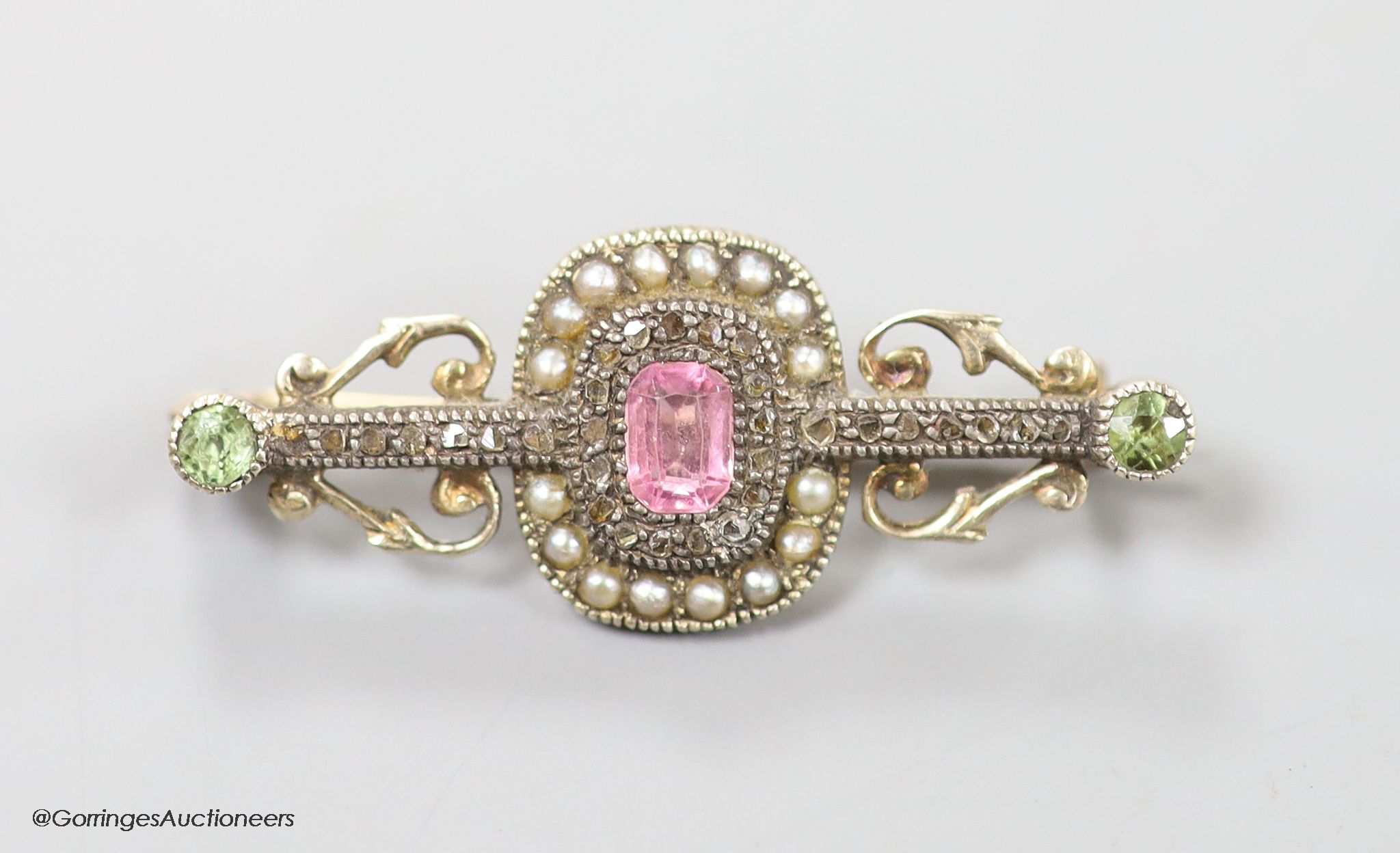 A late Victorian yellow metal, pink spinel?, green garnet, seed pearl and rose cut diamond set bar brooch, 35mm, gross weight 4.2 grams.